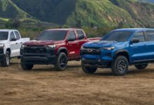 Trucks white, red and blue Chevy Colorado models parked outdoors