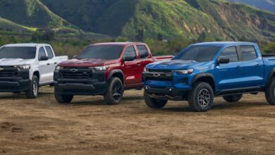 Trucks white, red and blue Chevy Colorado models parked outdoors