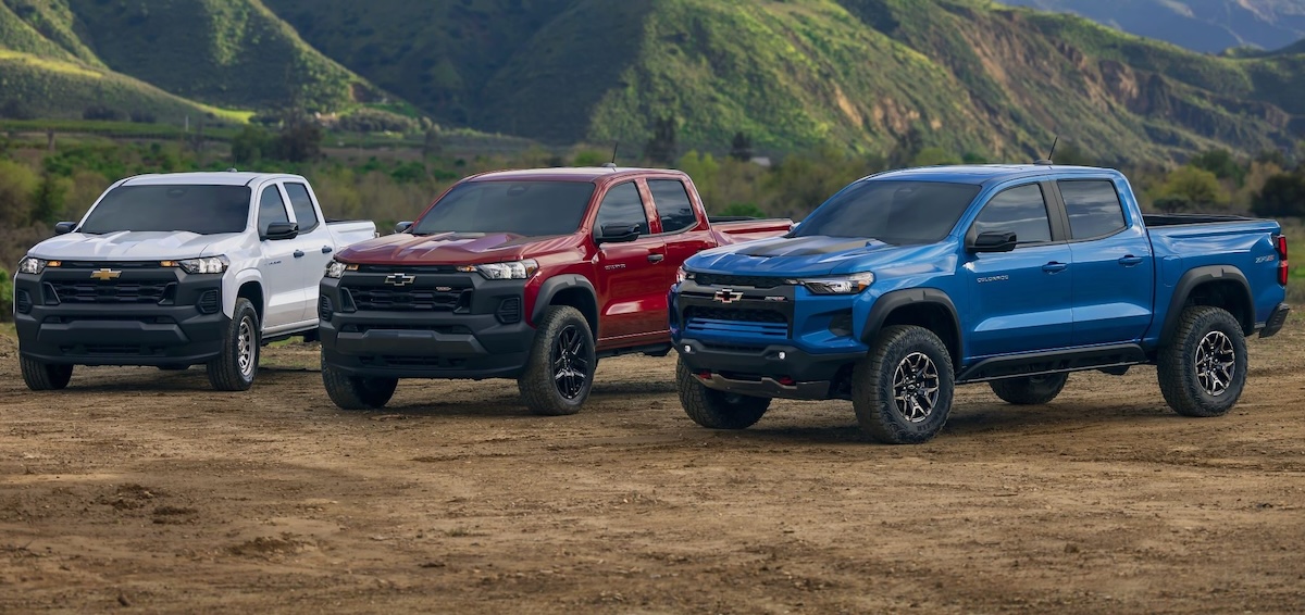 Trucks white, red and blue Chevy Colorado models parked outdoors
