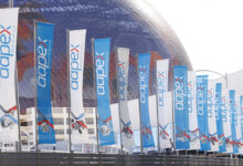 AAPEX flags in front of sphere