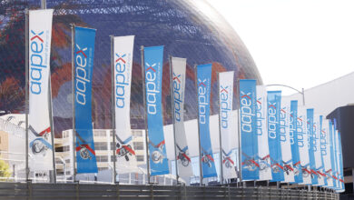 AAPEX flags in front of sphere