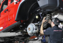 Auto tech working under Jeep