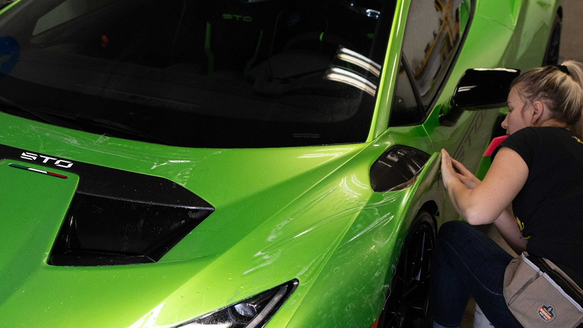 Person applying wrap to Lamborghini
