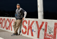 Brian Scotto leaning against concrete barrier