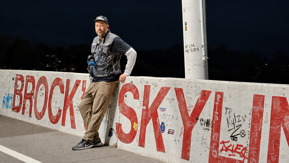 Brian Scotto leaning against concrete barrier