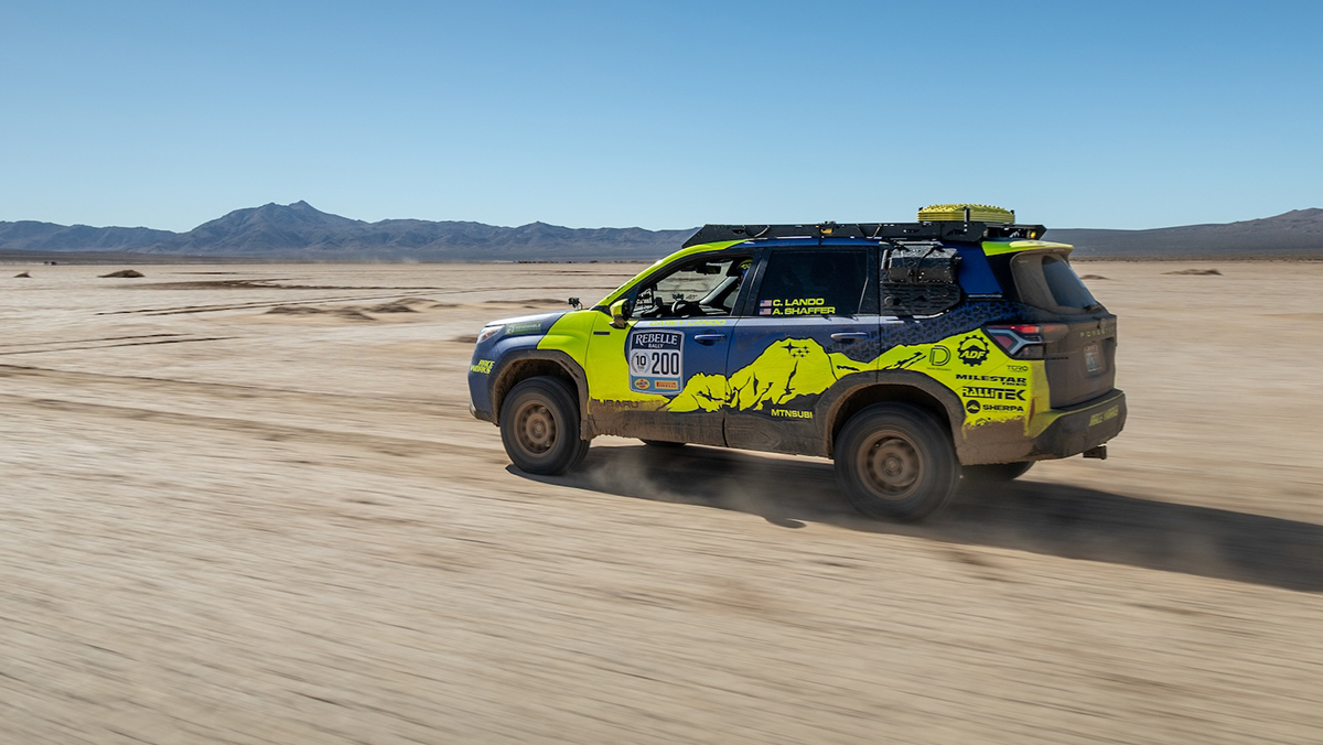 2025 Subaru Forester Hybrid racing across desert.