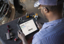 Auto mechanic using tablet