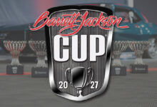 Barrett-Jackson Cup logo with trophies and car in background