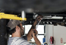 Mechanic working under car