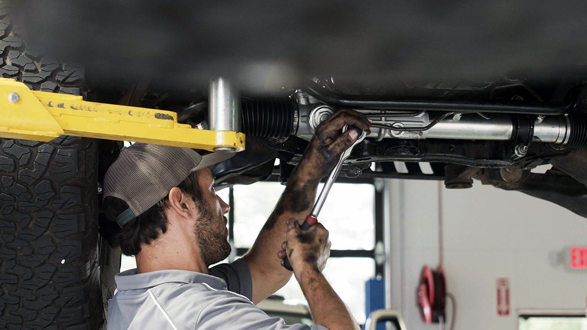 Mechanic working under car