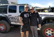 Kelly and Troy Davis standing in front of a Jeep