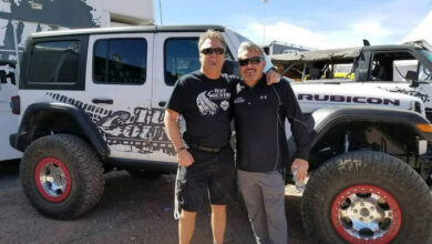 Kelly and Troy Davis standing in front of a Jeep