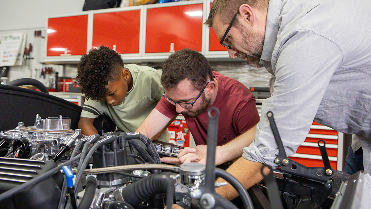 Adults and kids working on the custom 2026 Factory Five Mk5 Roadster